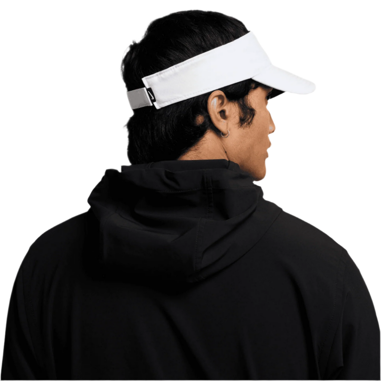 Person wearing a black hoodie and white visor on a light gray background