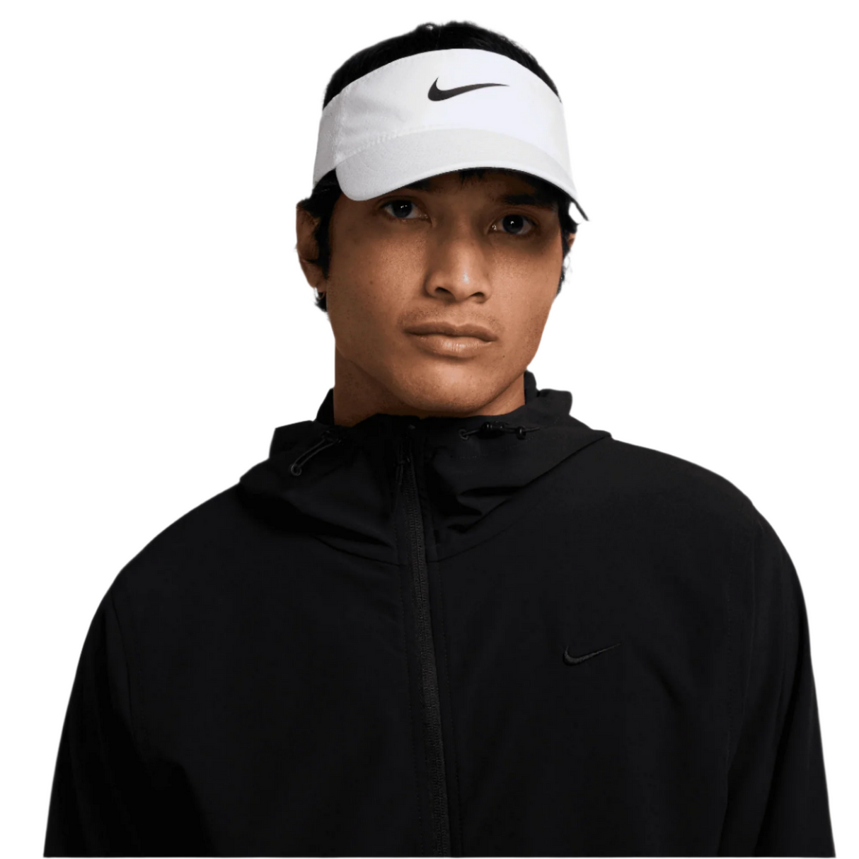 Person wearing a black jacket and white Nike visor on a white background