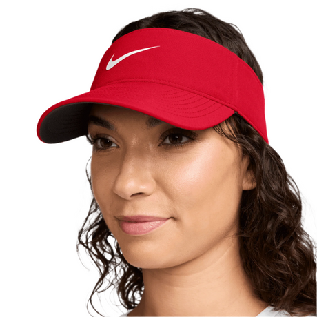 Woman wearing a red Nike visor against a white background