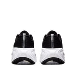 Black and white athletic shoes on a light gray background