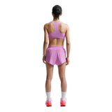 Person wearing a pink athletic outfit on a white background