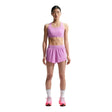 Person wearing a pink athletic outfit with Nike logo on a white background