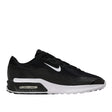 Black sneaker with white accents on a light gray background