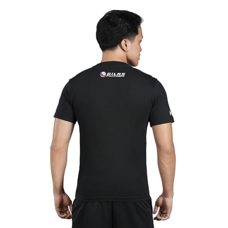 Person wearing a black t-shirt with a logo on the back against a white background