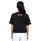 Person wearing a black t-shirt with branding on the back, standing against a white background