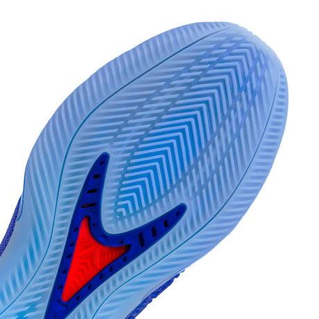 Close-up of a sneaker sole showing a translucent light blue textured outsole with a blue and red logo detail, on a light gray background.